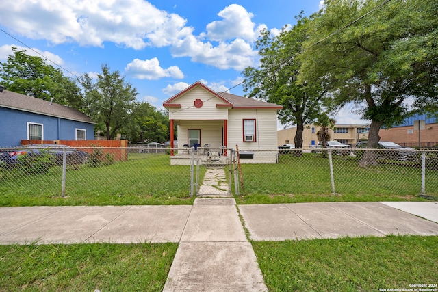 bungalow-style home with a front lawn