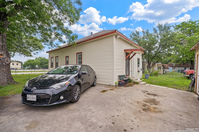 view of side of home featuring a yard