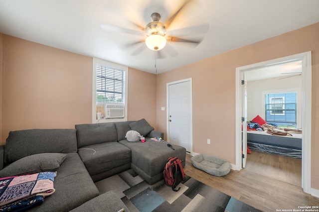 living room featuring ceiling fan and hardwood / wood-style floors