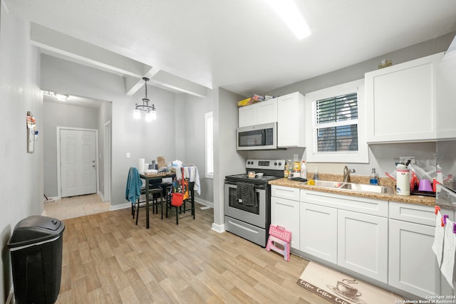 kitchen featuring hanging light fixtures, light hardwood / wood-style flooring, stainless steel appliances, white cabinetry, and sink