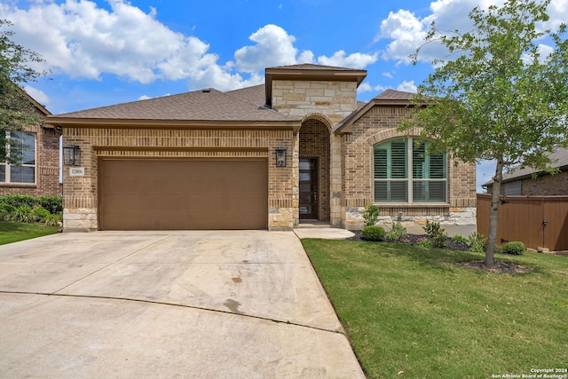 view of front of property featuring a garage and a front yard