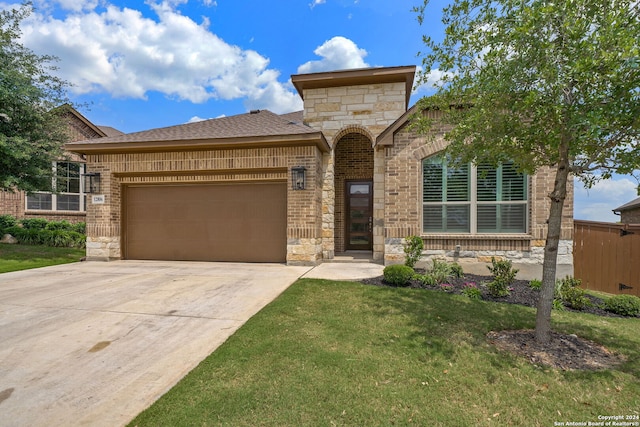 view of front of house featuring a garage and a front yard