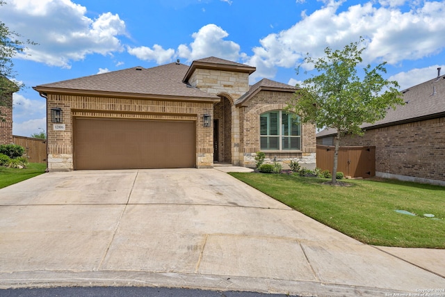 view of front of home with a garage and a front yard