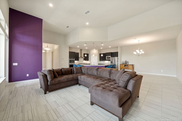 living room with a notable chandelier, a towering ceiling, and light tile floors