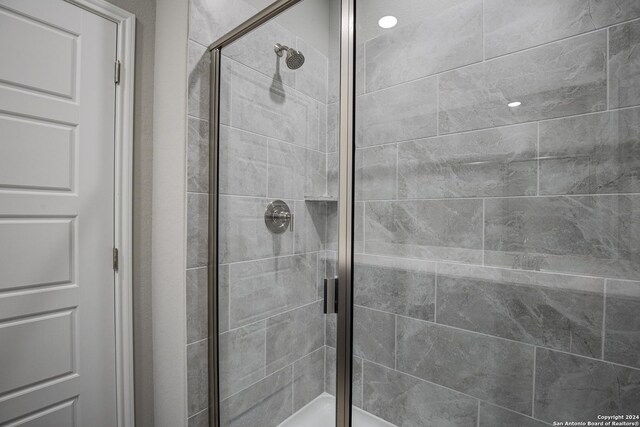 bathroom featuring a shower with shower door