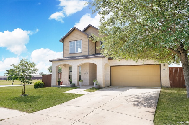 view of front of property featuring a front lawn and a garage