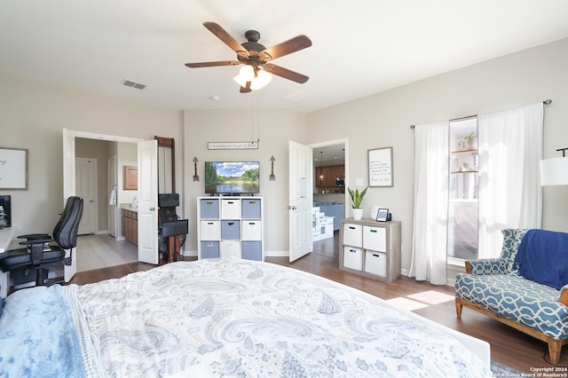 bedroom featuring ceiling fan, hardwood / wood-style flooring, and ensuite bathroom