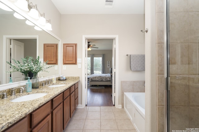 bathroom featuring independent shower and bath, tile flooring, ceiling fan, and dual vanity