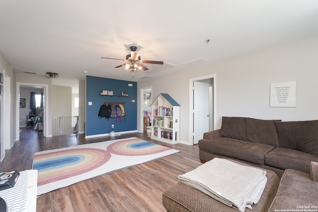 living room featuring hardwood / wood-style floors and ceiling fan