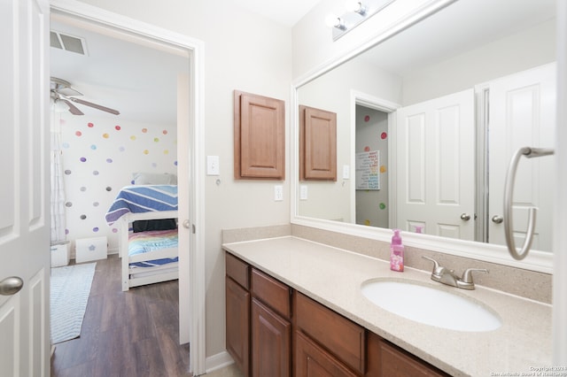 bathroom with wood-type flooring, ceiling fan, and vanity