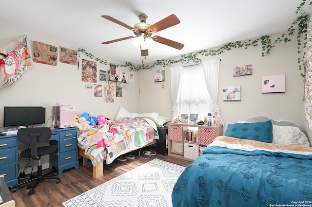 bedroom with dark hardwood / wood-style flooring and ceiling fan