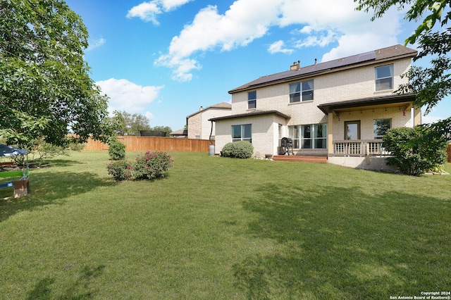 rear view of house with a lawn