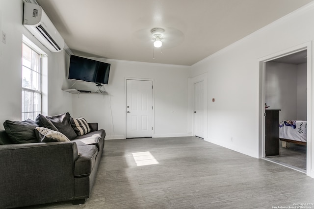 living room with an AC wall unit, crown molding, and ceiling fan