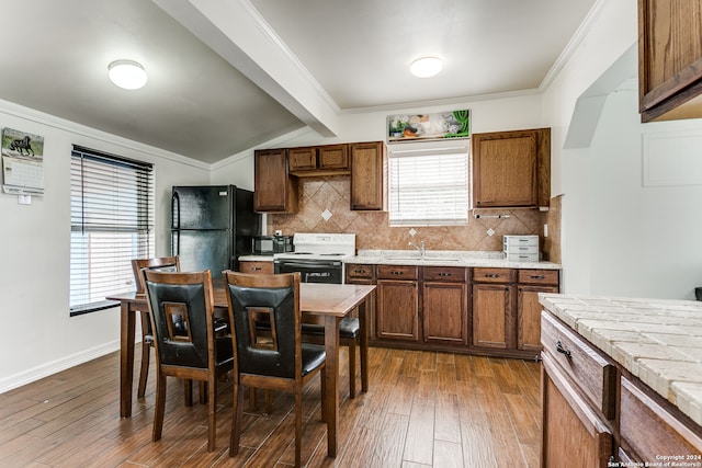 kitchen featuring beamed ceiling, black fridge, dark wood-type flooring, tasteful backsplash, and electric stove