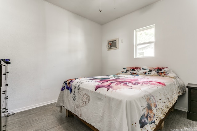 bedroom with dark hardwood / wood-style flooring