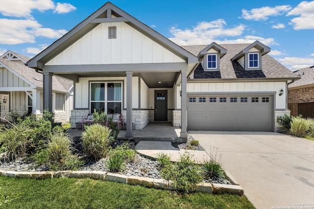 craftsman house featuring covered porch and a garage