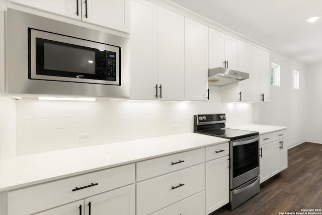 kitchen featuring appliances with stainless steel finishes, dark hardwood / wood-style floors, backsplash, and white cabinetry