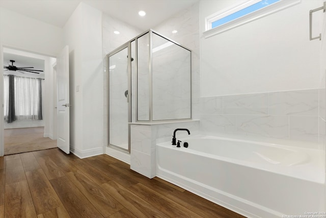 bathroom featuring wood-type flooring, ceiling fan, and separate shower and tub