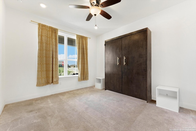 unfurnished bedroom featuring a closet, ceiling fan, and carpet flooring