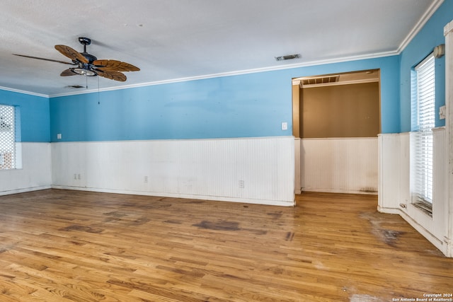 spare room featuring crown molding, wood-type flooring, and ceiling fan