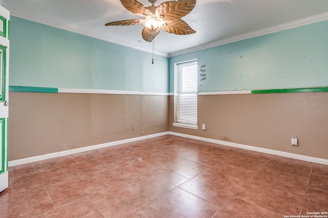 spare room with crown molding, tile floors, and ceiling fan