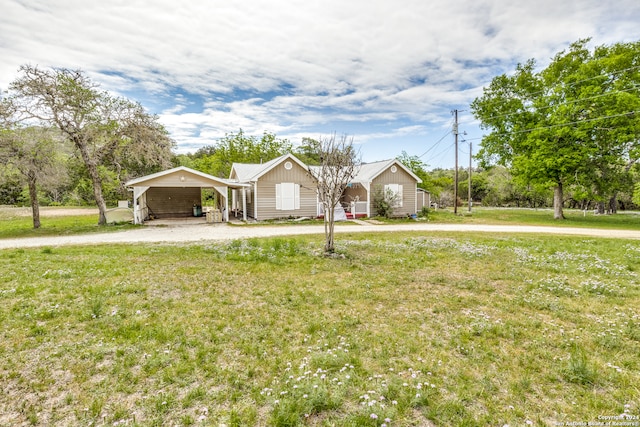 ranch-style home with a front yard and a carport