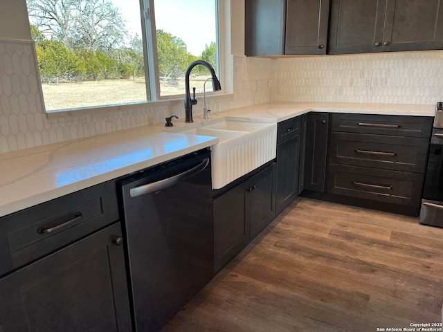 kitchen featuring plenty of natural light, light hardwood / wood-style flooring, sink, and stainless steel dishwasher