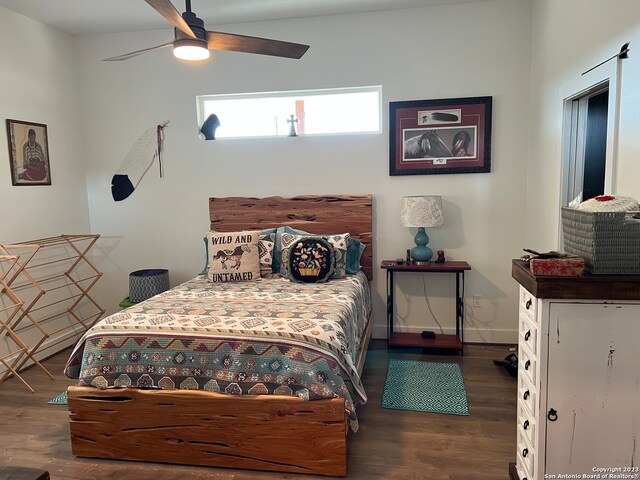 bedroom featuring dark hardwood / wood-style flooring and ceiling fan