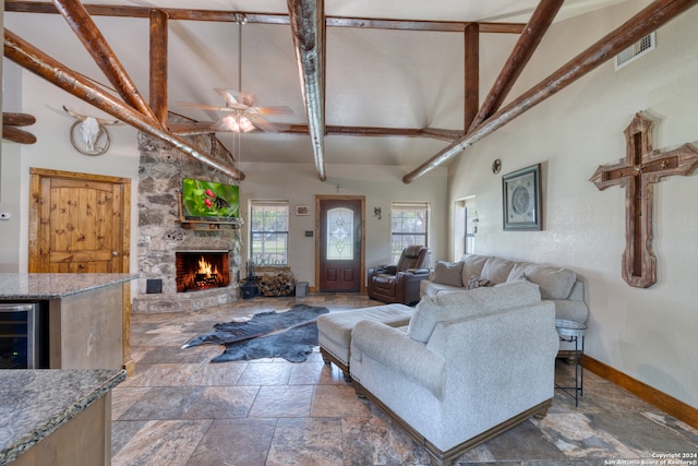 tiled living room with ceiling fan, a fireplace, wine cooler, high vaulted ceiling, and beam ceiling