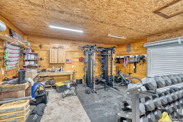 workout room featuring wooden walls and a workshop area