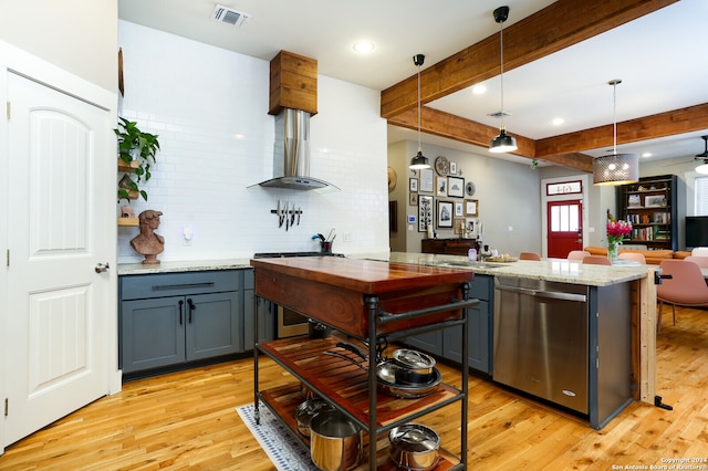 kitchen with decorative light fixtures, light wood-type flooring, wall chimney range hood, tasteful backsplash, and dishwasher