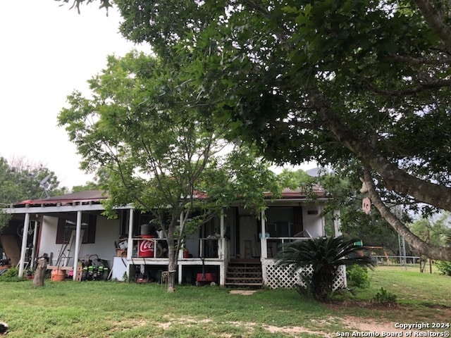 rear view of house with a lawn