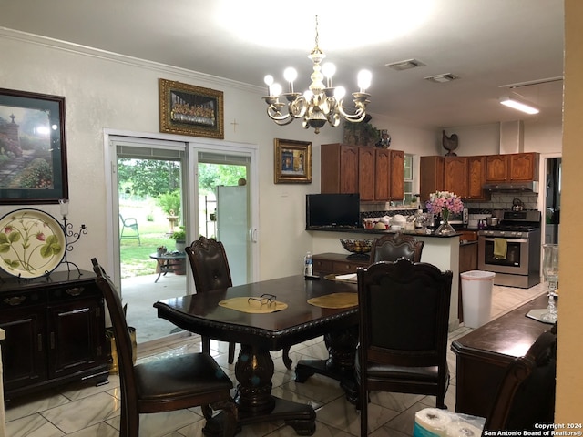 dining area with ornamental molding, light tile flooring, and an inviting chandelier