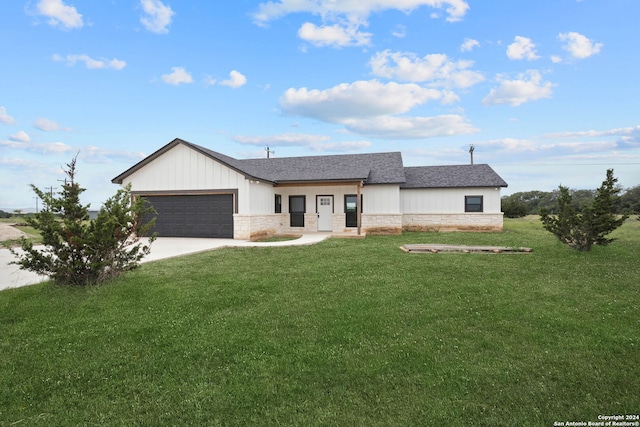 view of front of house with a front lawn and a garage