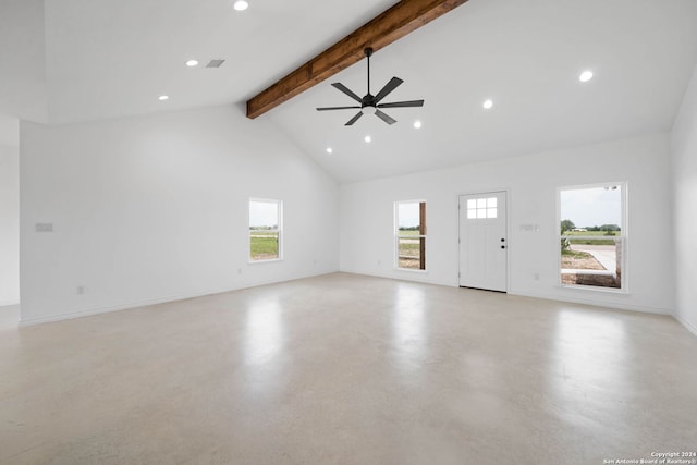 unfurnished living room with beamed ceiling, a healthy amount of sunlight, concrete floors, and ceiling fan