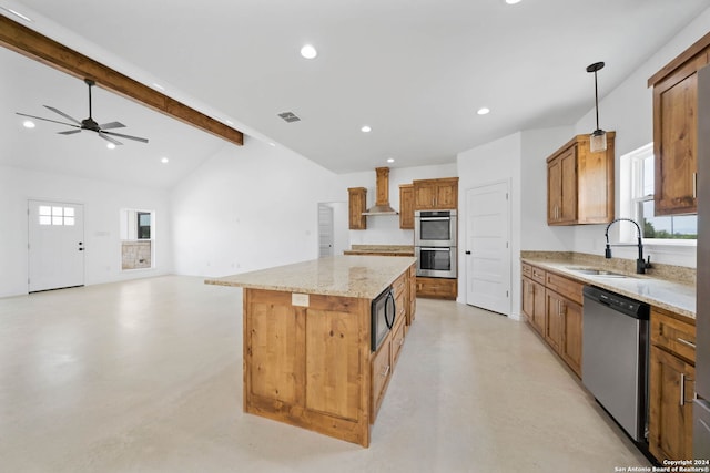 kitchen with hanging light fixtures, vaulted ceiling with beams, a center island, wall chimney exhaust hood, and appliances with stainless steel finishes