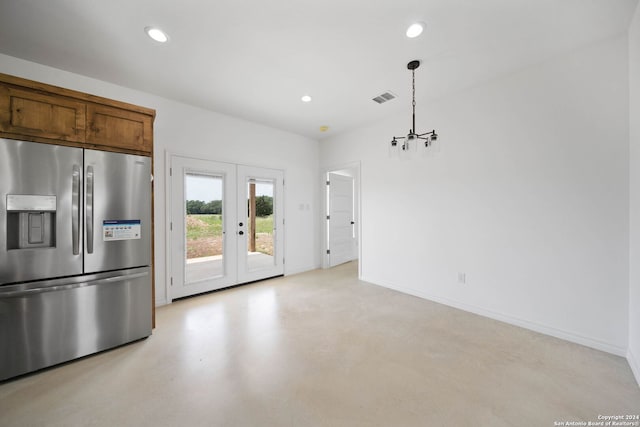 kitchen featuring decorative light fixtures, french doors, and stainless steel refrigerator with ice dispenser