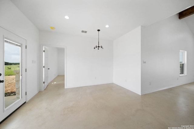 unfurnished room with a notable chandelier, beam ceiling, and concrete flooring