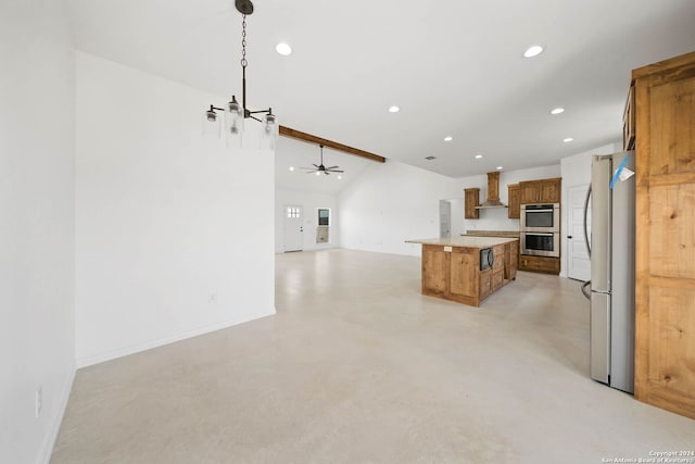 kitchen with hanging light fixtures, a kitchen island, stainless steel appliances, wall chimney exhaust hood, and ceiling fan