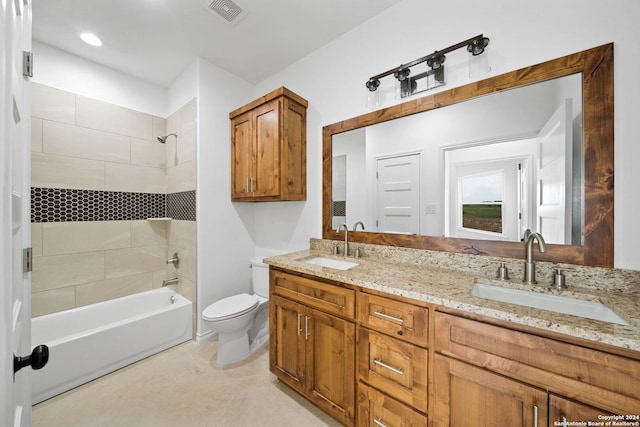 full bathroom featuring tiled shower / bath, double sink vanity, and toilet