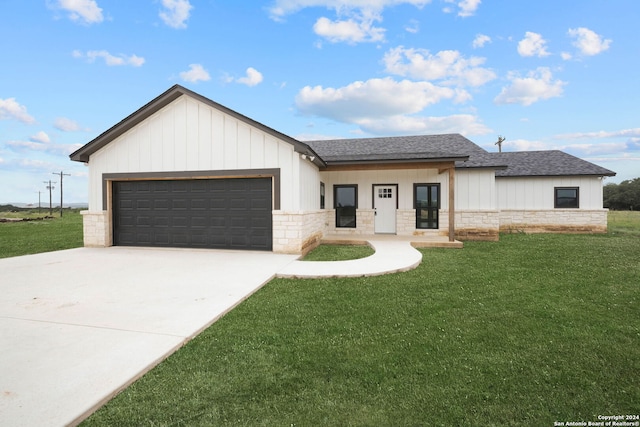 view of front of property featuring a garage and a front lawn