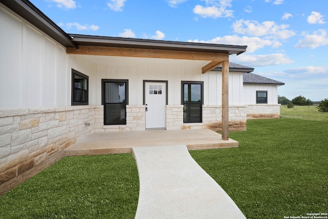 rear view of house with a patio area and a yard