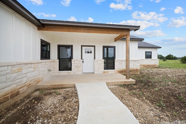 doorway to property with a patio