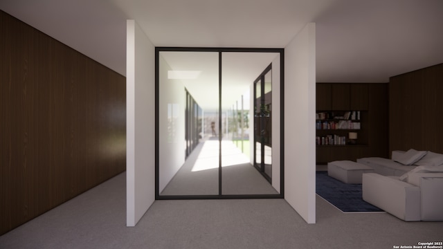 living room with wood walls and carpet flooring