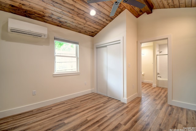 unfurnished bedroom featuring ceiling fan, wood-type flooring, lofted ceiling with beams, a wall unit AC, and wood ceiling