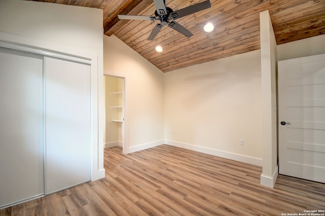 unfurnished bedroom with a closet, hardwood / wood-style flooring, wood ceiling, ceiling fan, and lofted ceiling