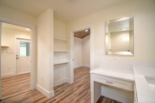 interior space featuring vanity and hardwood / wood-style flooring