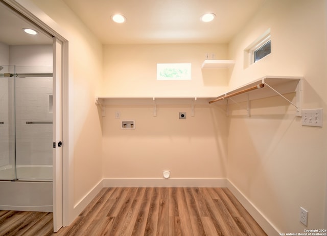 laundry room featuring hookup for a washing machine, hardwood / wood-style flooring, and electric dryer hookup