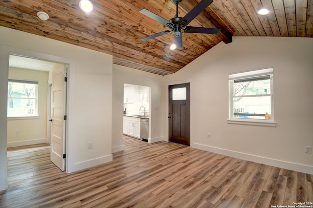 interior space with vaulted ceiling with beams, hardwood / wood-style floors, sink, wood ceiling, and ceiling fan