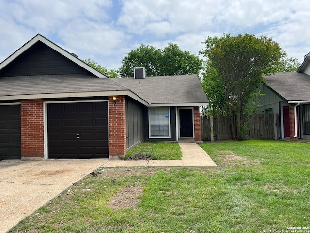 single story home featuring a garage and a front lawn